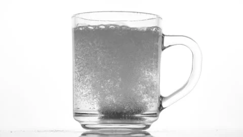 Effervescent tablet dissolve with bubbles in a glass of water Stock Footage 267678831