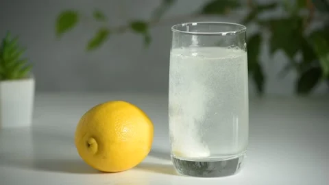 Effervescent tablet dissolves in a glass of clean water Stock Footage 171056334