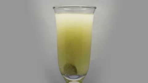 Effervescent tablet dissolves in a glass of water Stock Footage 102112024