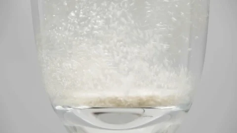 Effervescent tablet dissolves in a glass of water Stock Footage 102112041