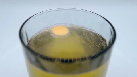 Effervescent tablet dissolving in water, vitamin pills for raising immune system Stock Footage 161179766