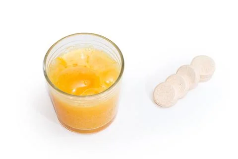 Effervescent tablet during dissolution in water glass, same tablets separatel Stock Photos