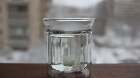 Effervescent tablet falling in water. Effervescent pill dissolving of water. Stock Footage 154463563