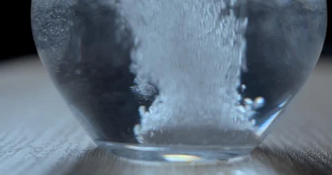 Effervescent tablet falling in water glass slowmotion 4K Stock Footage 93307615