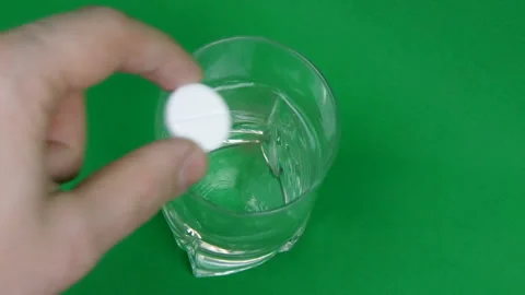 Effervescent Tablet Falling In Water. Pill Falls And Dissolves With Bubbles Video stock 126863446