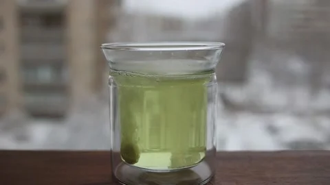 Effervescent tablet falling in water. Pill falls and dissolves with bubbles Stock Footage 154463572