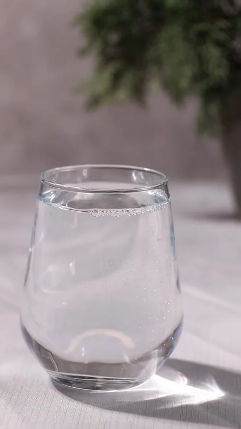 An effervescent tablet falls from above and begins to dissolve Stock Footage 296289374