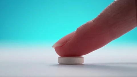 Effervescent Tablet is Pushed with a Finger and Left on Clean White Tabletop. Stock Footage 271006508