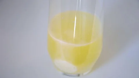 Effervescent tablet quickly dissolving in a water glass Stock Footage 80383093