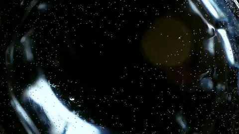 Effervescent tablet in slow motion closeup drops into a glass of water. Video stock 97761959