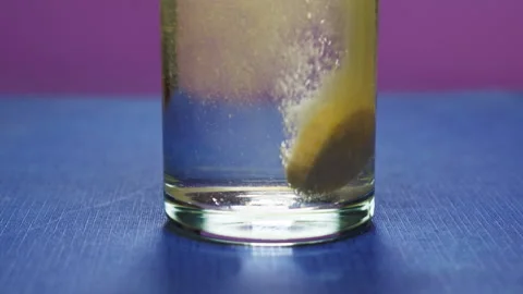 Effervescent tablet vitamin C nutritional supplements in glass with orange Stock Footage 263088420