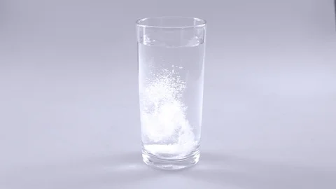 Effervescent tablets dissolving in water slow motion Stock Footage 103318679