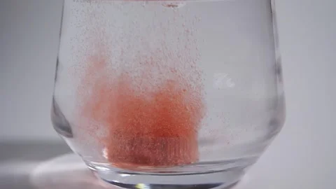Effervescent tablets dropping into a glass of water Stock Footage 308061616