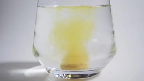 Effervescent tablets dropping into a glass of water 스톡 동영상 308062833