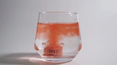 Effervescent tablets dropping into a glass of water 스톡 동영상 308063024