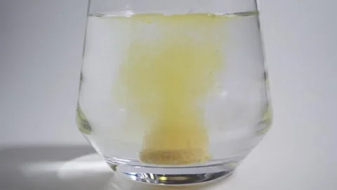 Effervescent tablets dropping into a glass of water 스톡 동영상 308063427