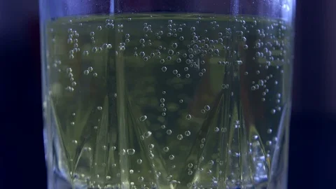 Effervescent tablets fall into a glass of water Stock Footage 83682407