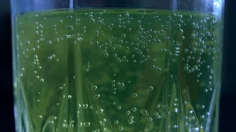 Effervescent tablets fall into a glass of water Stock Footage 83682449