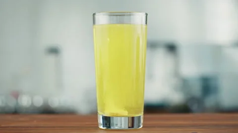 Effervescent tablets vitamin C nutritional supplements in glass with yellow Stock Footage 168893630