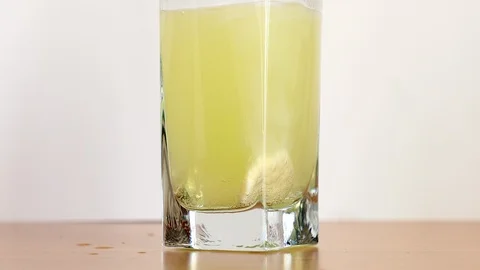 Effervescent vitamin C tablet bubbles in glass of water Stock Footage 88660777