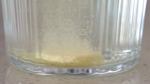 Effervescent Vitamin Tablet Dissolving in a Clear Glass of Water Video stock 330146392