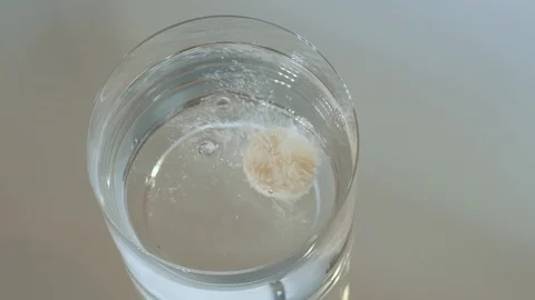 Effervescent vitamin tablet dissolving in glass of water. 4K resolution Stock Footage 126008306