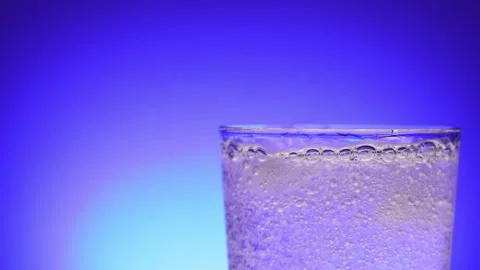 Effervescent Water Sparkle on Blue Gradient Stock Footage 256763638