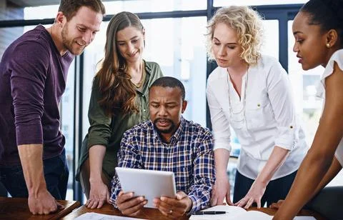 Efficiency is increased through teamwork. a team of designers working together Stock Photos