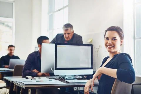 Efficient and productive, thats us. Portrait of young businesswoman using a Stock Photos