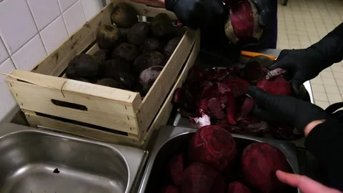 Efficient beetroot sorting and peeling process in industrial kitchen setting Stock Footage 307348654