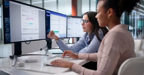 Efficient Black Business Managers Using System To Calculate Invoices And Taxe Stock Photos