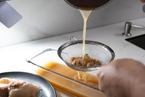 Efficient Bone Broth Preparation: Straining Process for Nutrient-Rich Stock Stock Photos