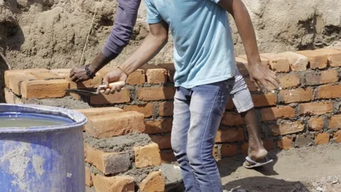 Efficient Bricklaying - Skilled Workers Crafting a Strong Foundation Stock Footage 314466814