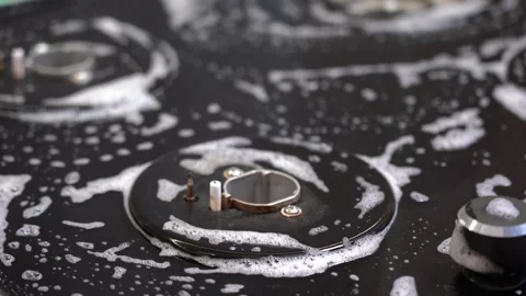 Efficient Cleaning Process: Scrubbing a Greasy Surface with a Sponge to Remove Stock Footage 321050813