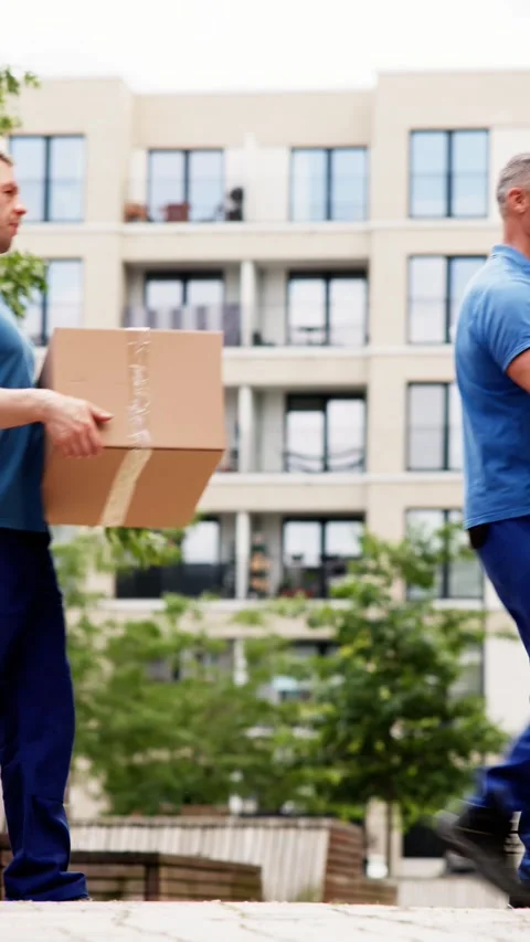 Efficient Delivery Team of Smiling Men Transporting Cardboard Boxes Outdoors 스톡 동영상 279801971