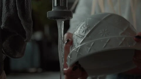 Efficient dish washing bowl tap in a modern kitchen sink setup Stock Footage 321379005