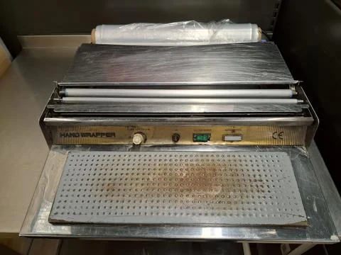 Efficient hand wrapper machine for sealing items Stock Photos