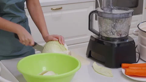 Efficient Home Cook Slices Cabbage Near Food Processor to Make Sauerkraut Stock Footage 321152726