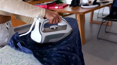 Efficient Ironing in a Modern Home Setting Stock Footage 309919336