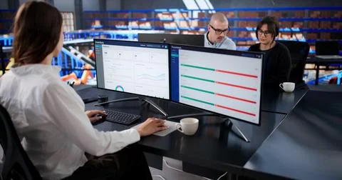 Efficient Logistics Center: Man And Woman Managing Automated Inventory Safely Stock Photos