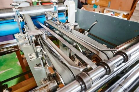 Efficient machine transforms flat cardboard into ready-to-use folded boxes in a Stock Photos