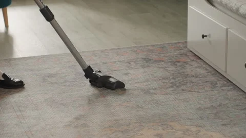 Efficient morning cleaning of textured carpet with vacuum. Woman performing Stock Footage 336868122