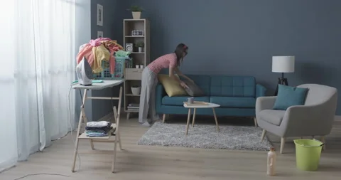 Efficient multitasking housewife doing chores at home Stock Footage 150885384