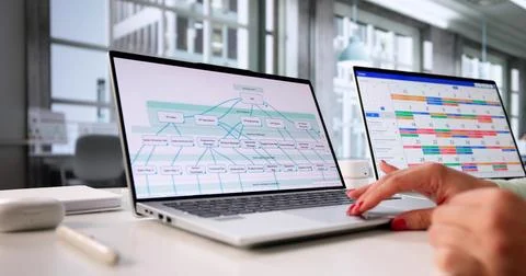 Efficient Project Manager Analyzing Data On Organizational Chart With Laptop. Foto stock