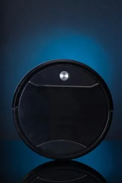 Efficient smart vacuum cleaner ready for action in a stylish modern setting with Stock Photos