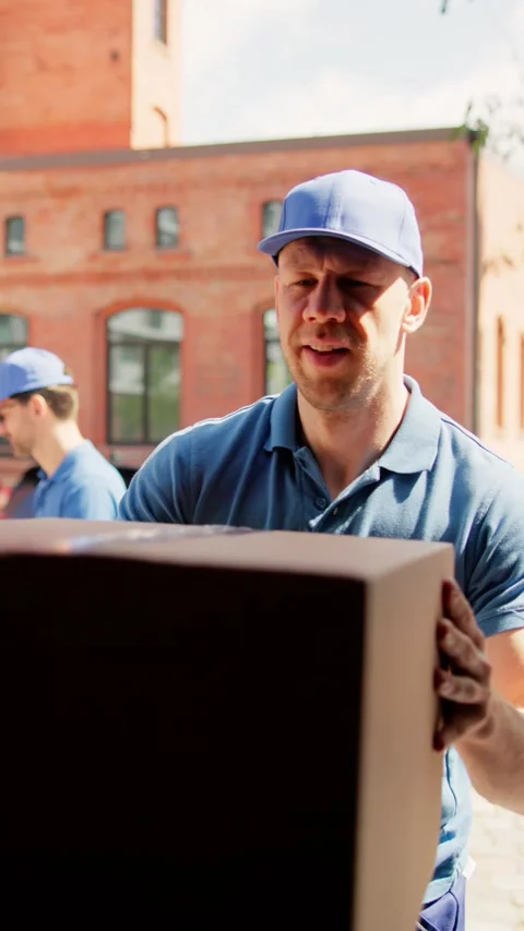 Efficient Teamwork: Young Delivery Men Loading Cardboard Boxes in Truck 스톡 동영상 279219174