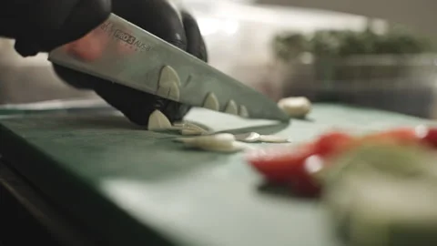 Efficient Vegetable Cutting on a Wooden Cutting Board Stock Footage 262184962