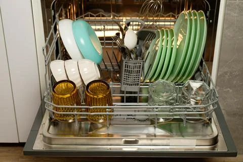 Efficiently arranged kitchenware in a modern dishwasher for maximum cleaning Stock Photos