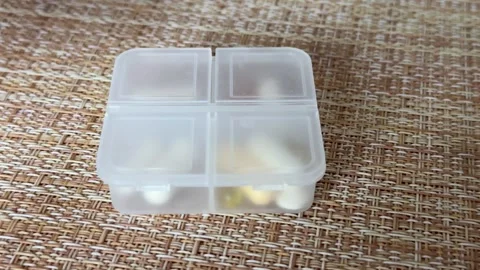Efficiently Organizing Medication in a Pill Box for Better Daily Health Stock Footage 316391665