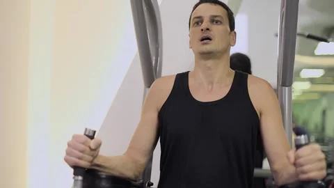Effort on face of man which lifts his legs during abdominal training. Slow Stock Footage 276376299